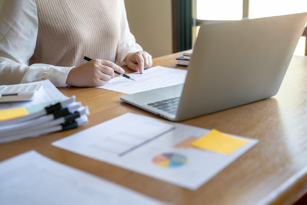 Businesswoman Accountant analyzing investment charts Invoice and